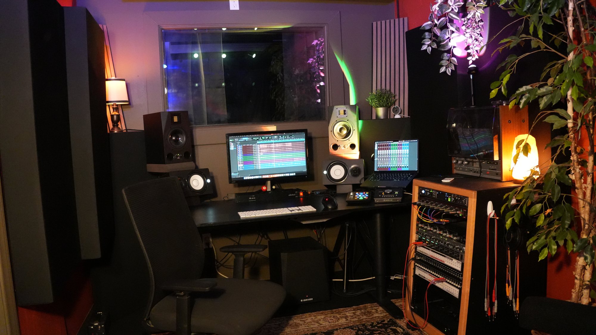 studio b — the desk and the vocal booth behind the glass